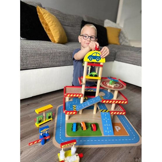 Tomi's wooden garage with lift, toy cars and helicopter