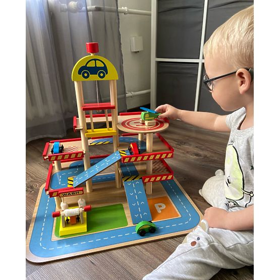 Tomi's wooden garage with lift, toy cars and helicopter
