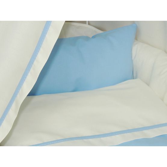 Wicker cot with blue set bedding